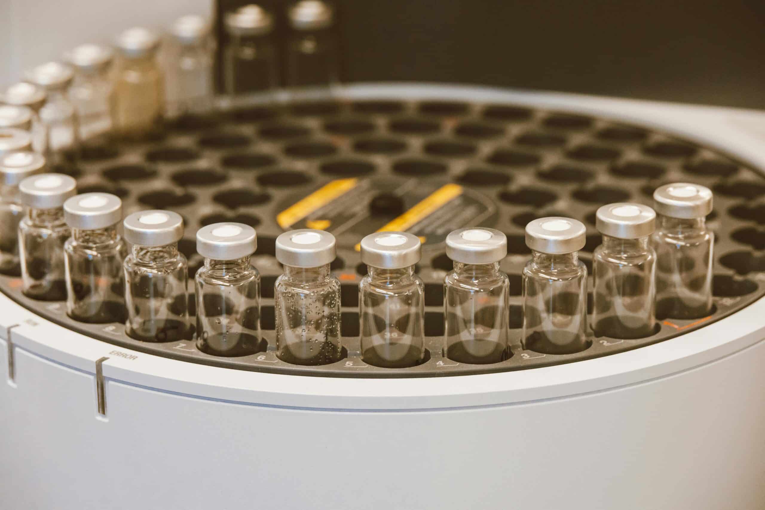 An array of glass vials in a lab setting, ideal for scientific research visuals.
